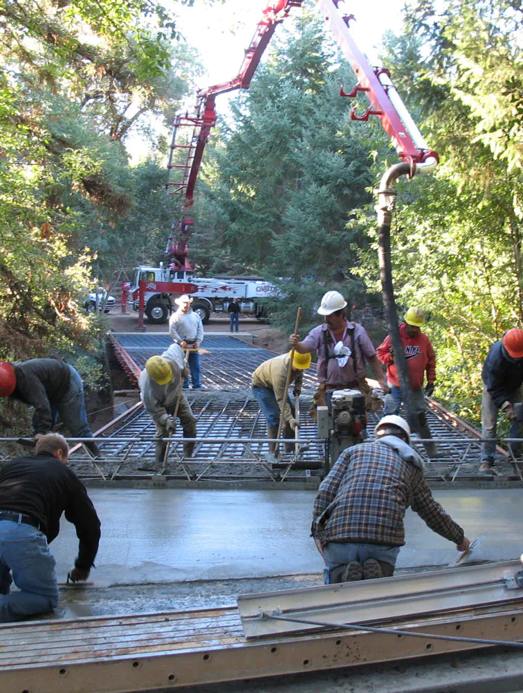 Photo of workers pouring concrete bridge